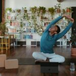 ‘마이크로 운동’ 바람, 일상 속 움직임으로 건강 챙기기 a man is doing yoga in a living room